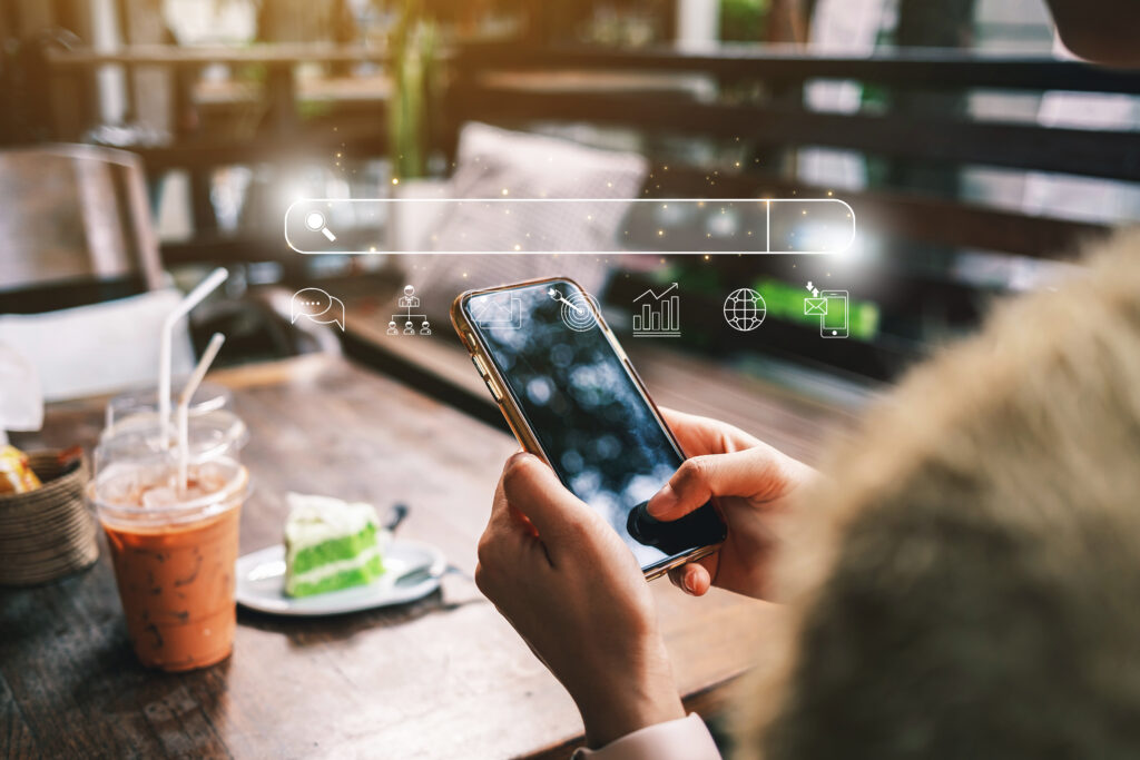 Person searching on a smartphone in a cafe